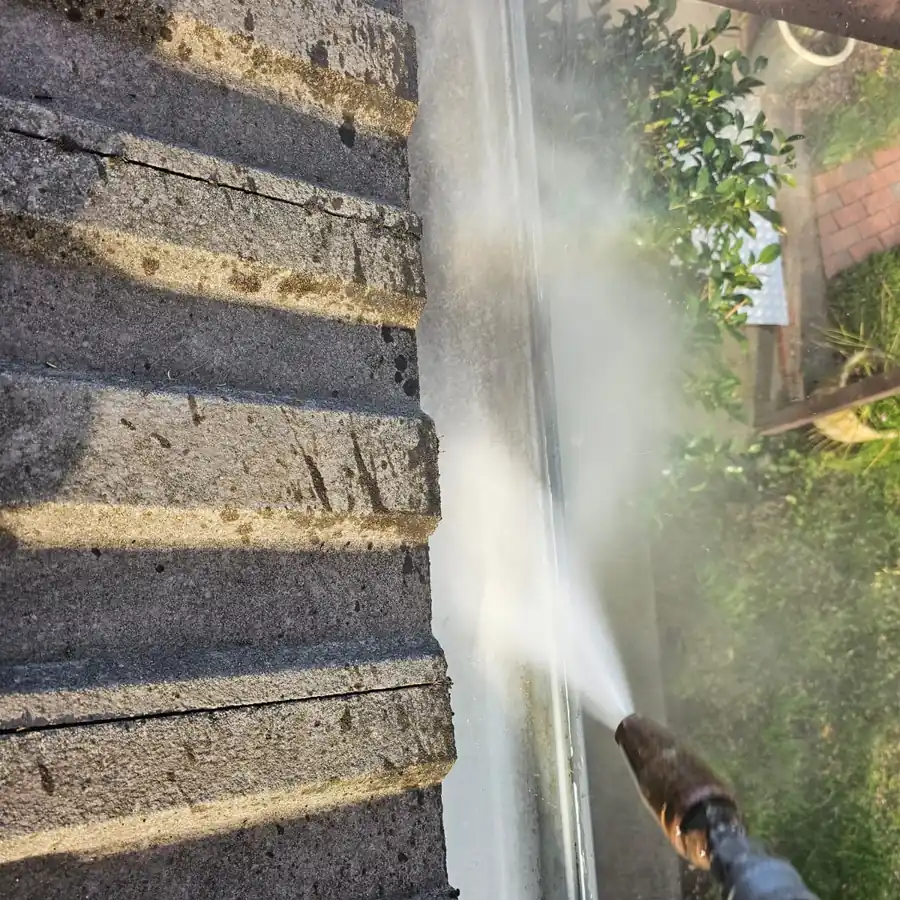 Pressure cleaning being used on an exterior tiled surface